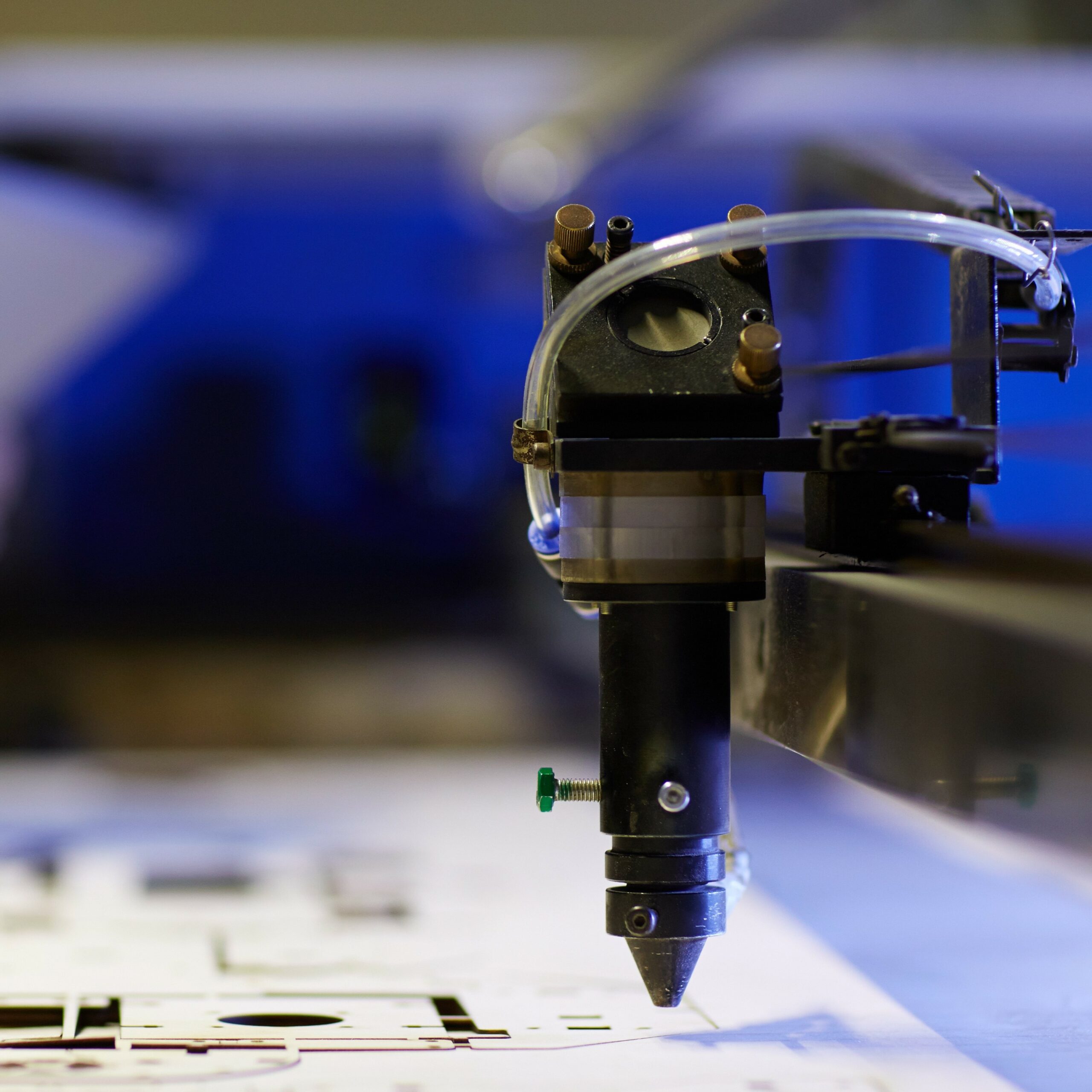 Laser cutting beam over plywood sheet